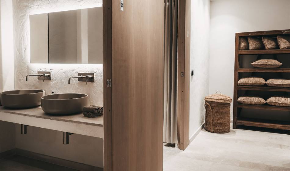 Waschbereich im Wellnessbereich des Barefoot Hotels Mallorca mit modernen Waschbecken und einem Regal mit Kissen.
