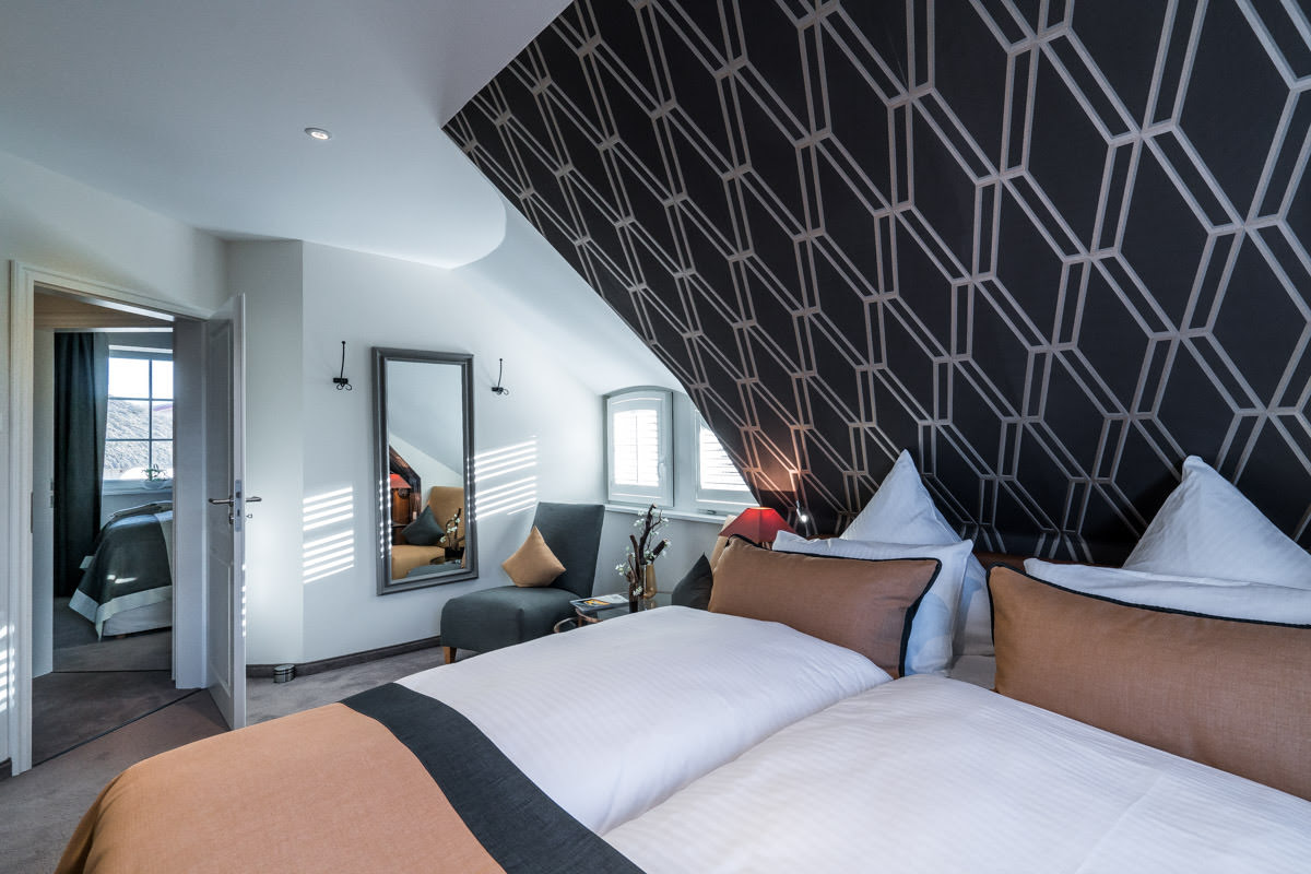 Luxurious bedroom in the vacation home Seewind, part of the Hotel Künstlerquartier Seezeichen, with harmonious colors.