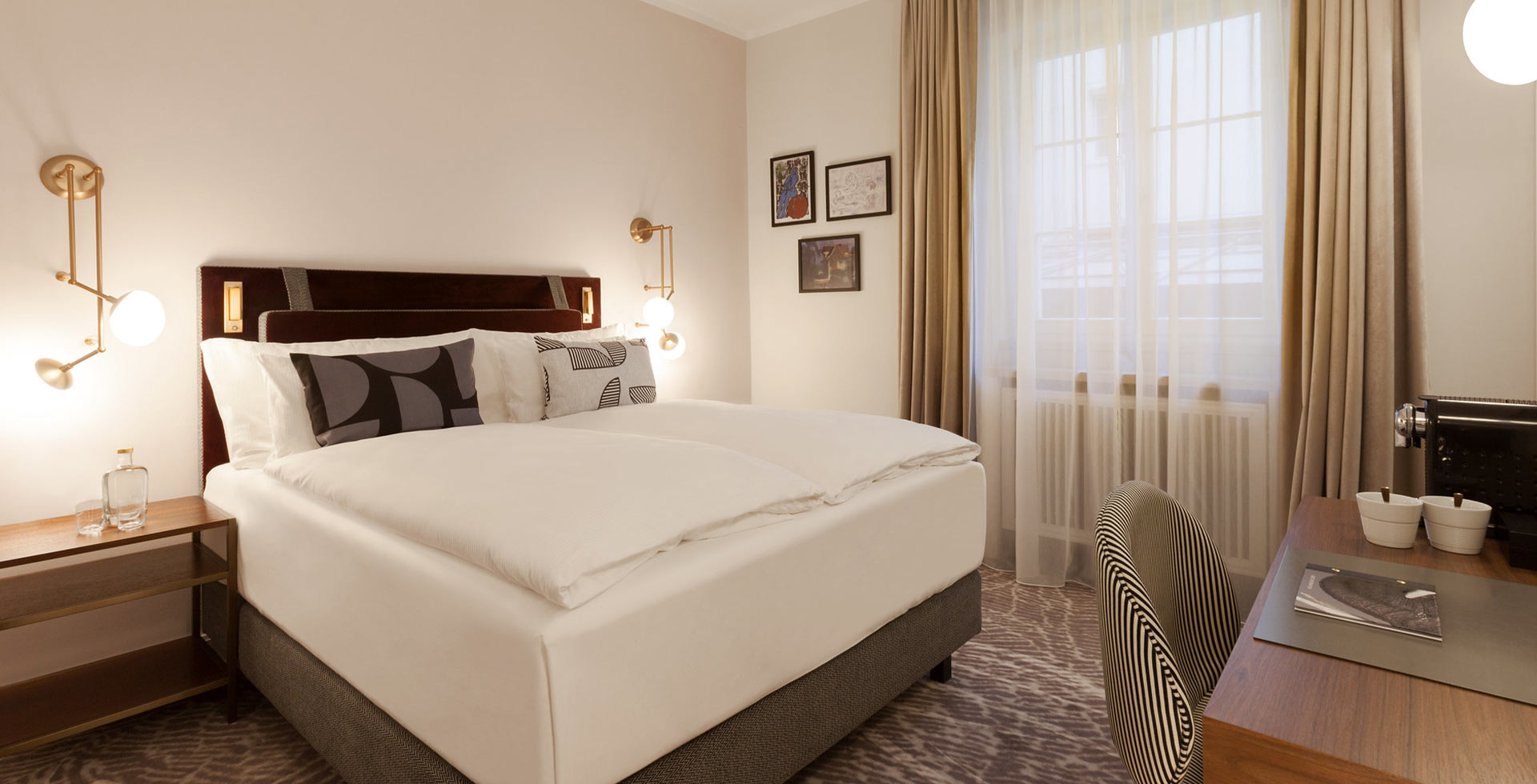 Doppelzimmer mit hochwertiger, eleganter Einrichtung und feinen Details in Olivgrün und Gold.
